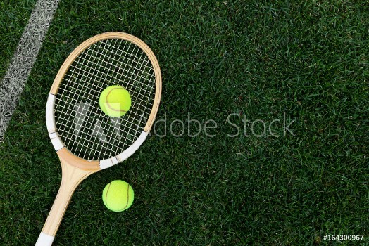 Bild på Retro tennis racket on natural grass with balls top view with copy space